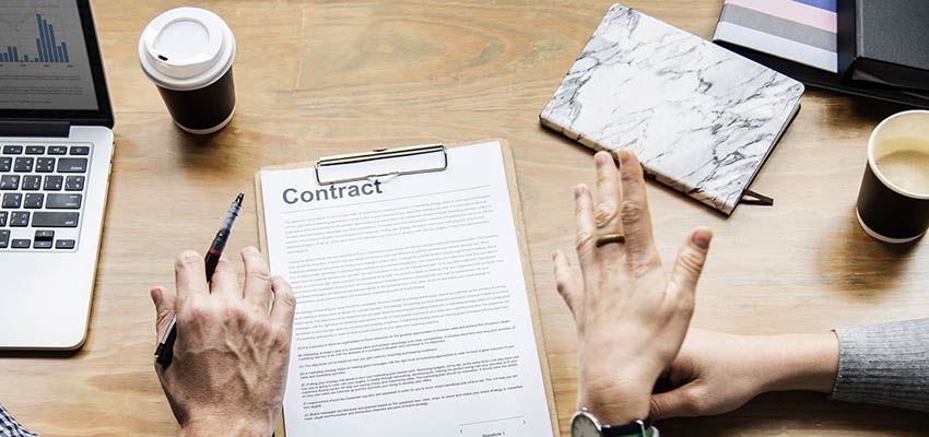 Two people reviewing a contract.