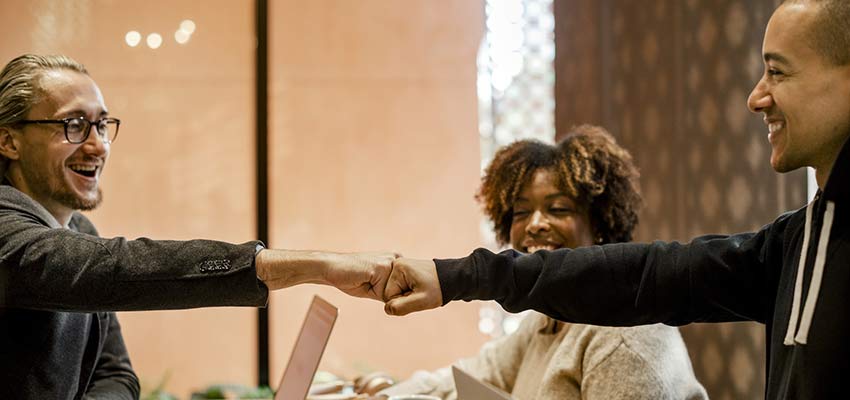 A group of people giving each other a fist bump.