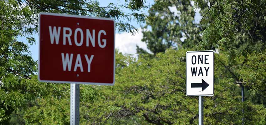 "Wrong Way" and "One Way" road signs