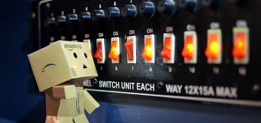 A cardboard robot looking at a series of switches.
