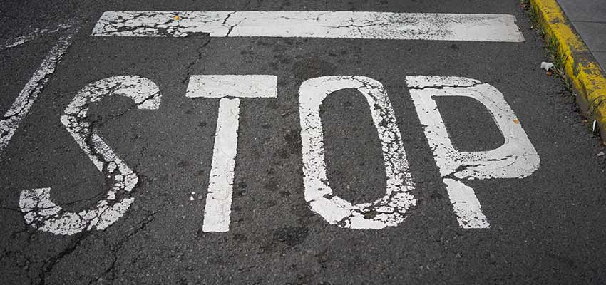 A road with "STOP" painted on it.