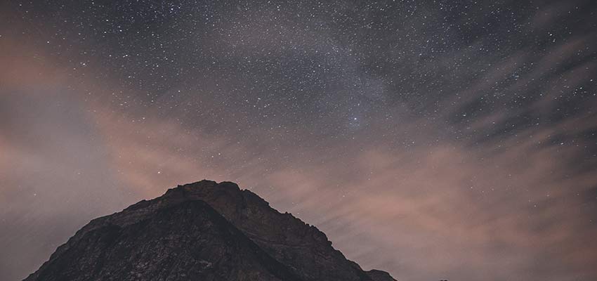 A mountain on a starry night.