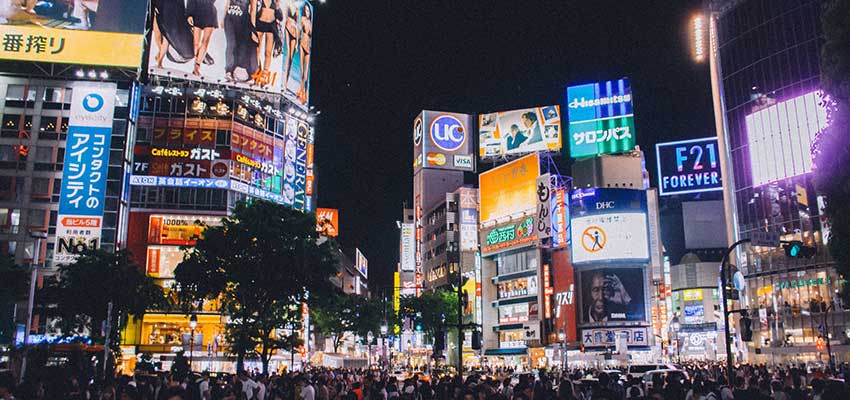 A city with many brightly colored ads.