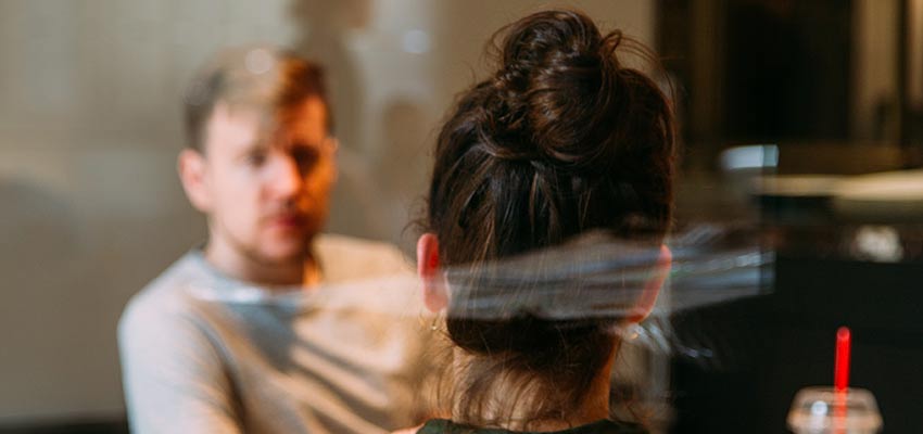 A woman and man having a discussion.