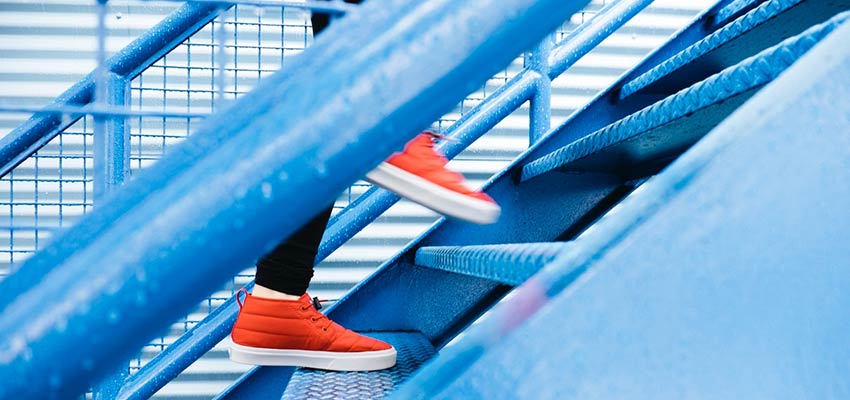 Person walking up a flight of stairs.