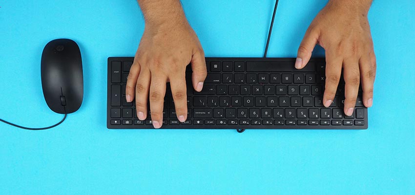 A person typing on a keyboard.