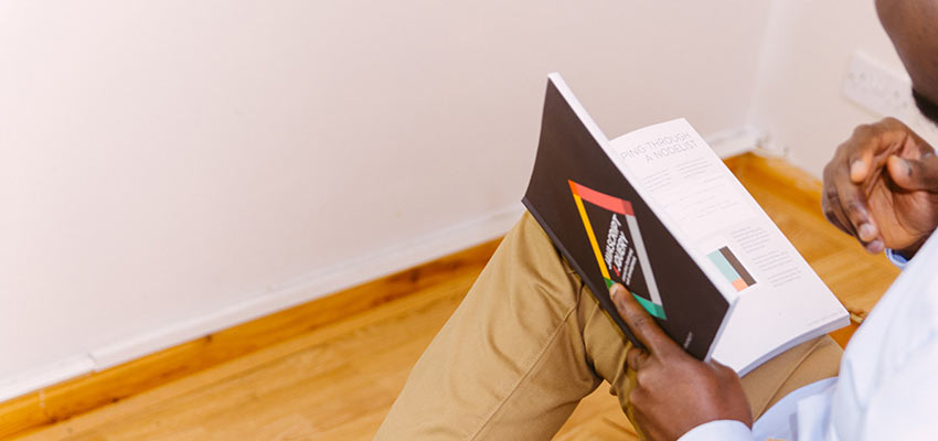 A man reading a JavaScript book.