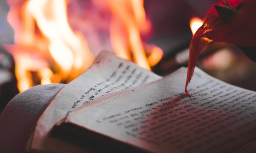 text on paper and fire behind